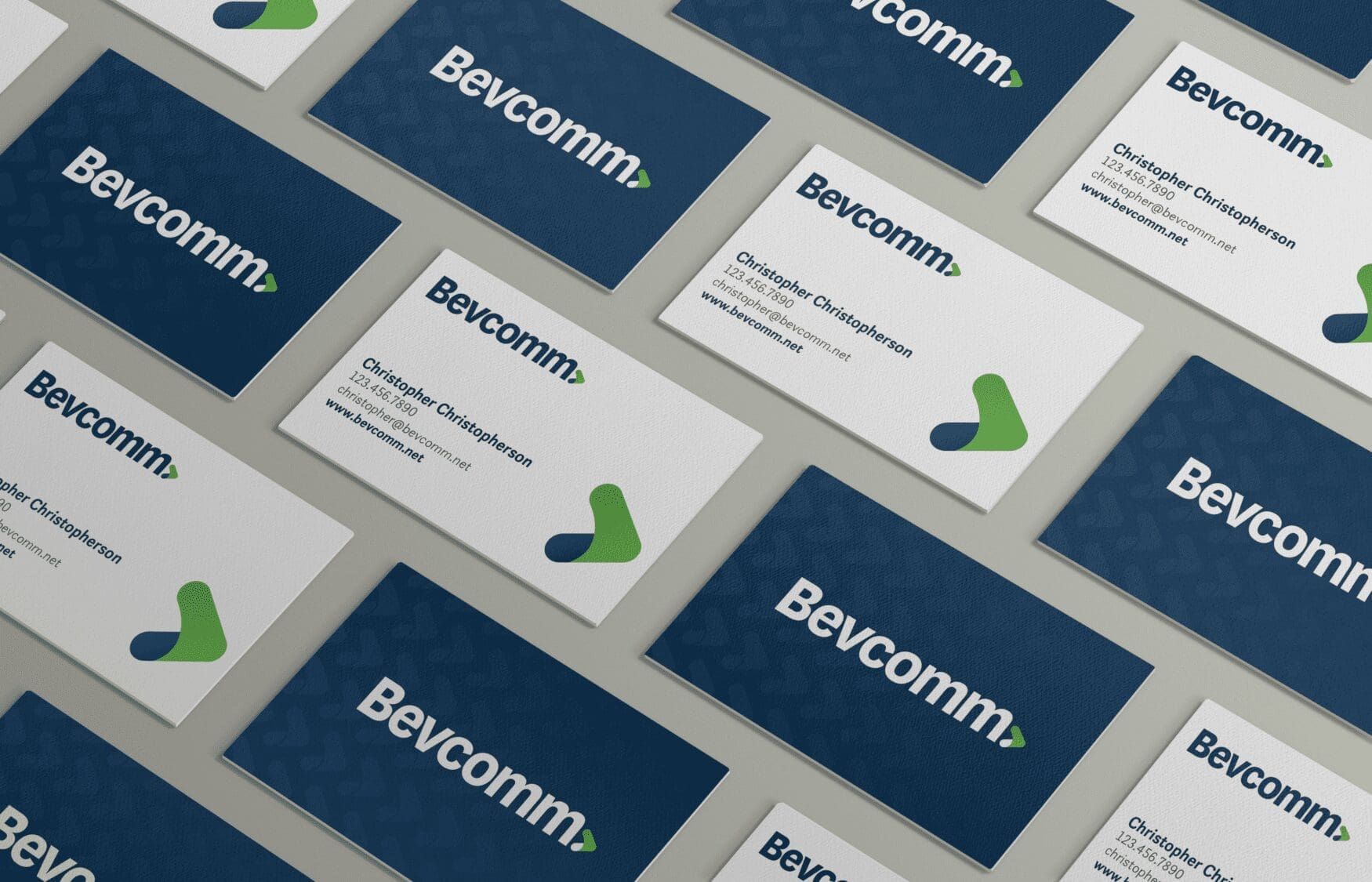 Mockup of business cards for Bevcomm, showing a pattern design on a light background.