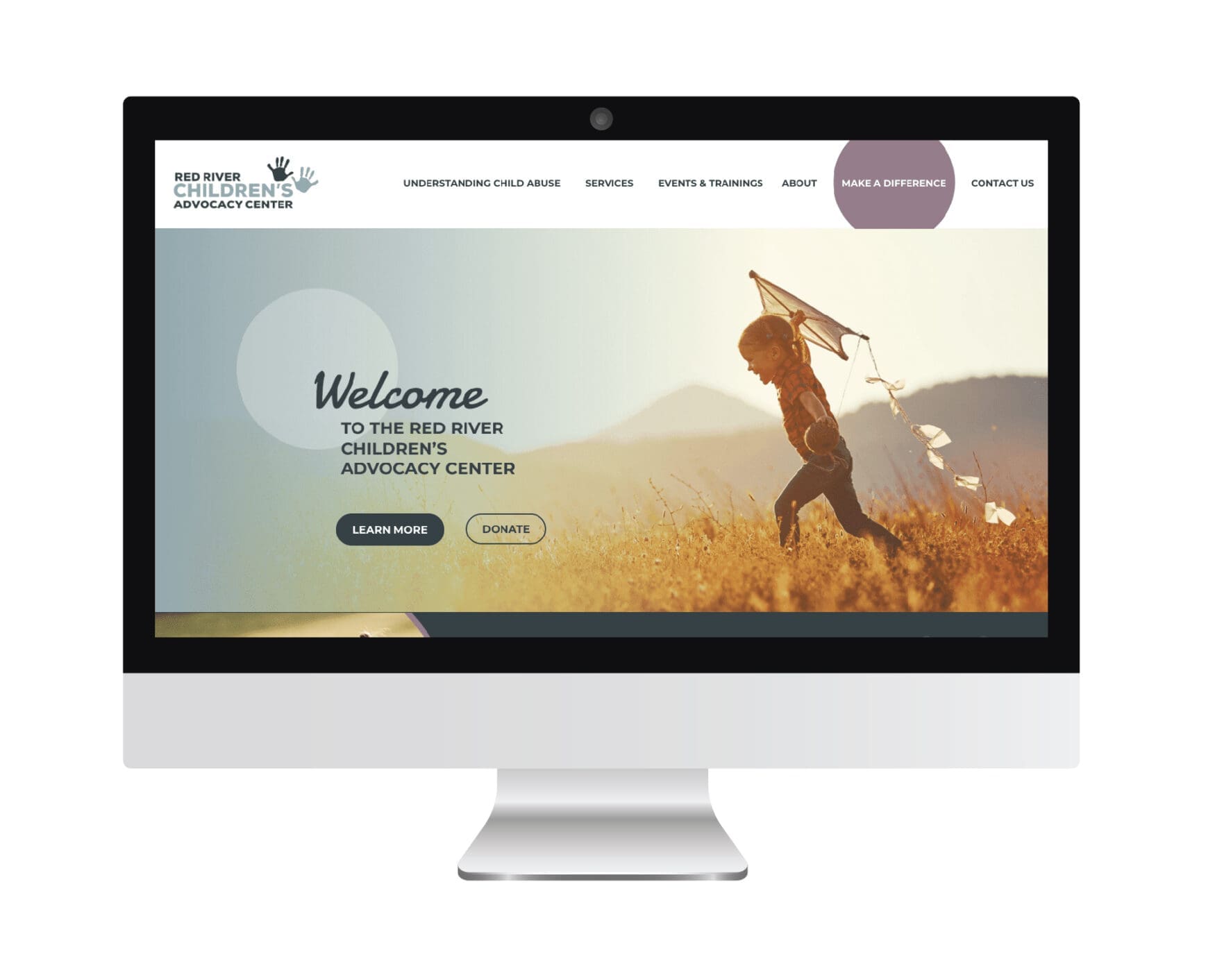 Homepage of the Red River Children’s Advocacy Center featuring a child running with a kite and a welcome message with buttons to learn more and donate, all displayed on a computer screen