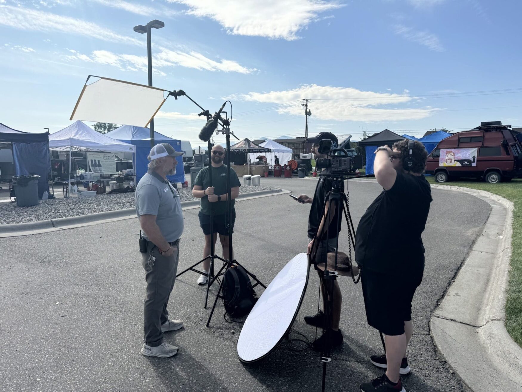 Max, Lucas, and Jordan all help film as the interview a man in a baseball cap