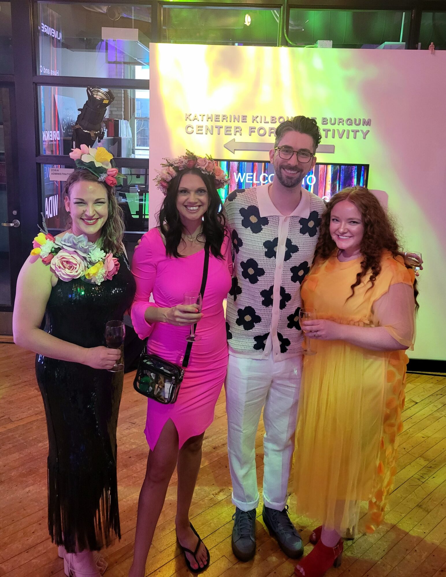 Four colorfully dressed individuals pose for a picture.