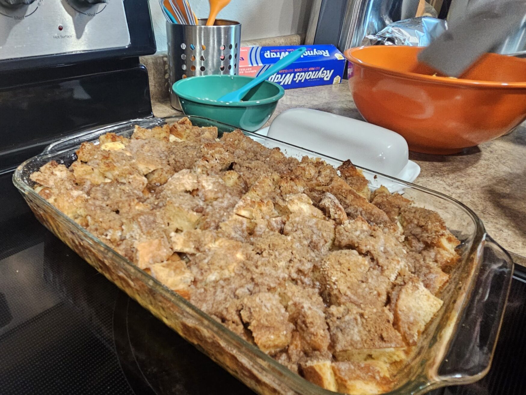 A tray of french toast casserole sits on a stovetop.