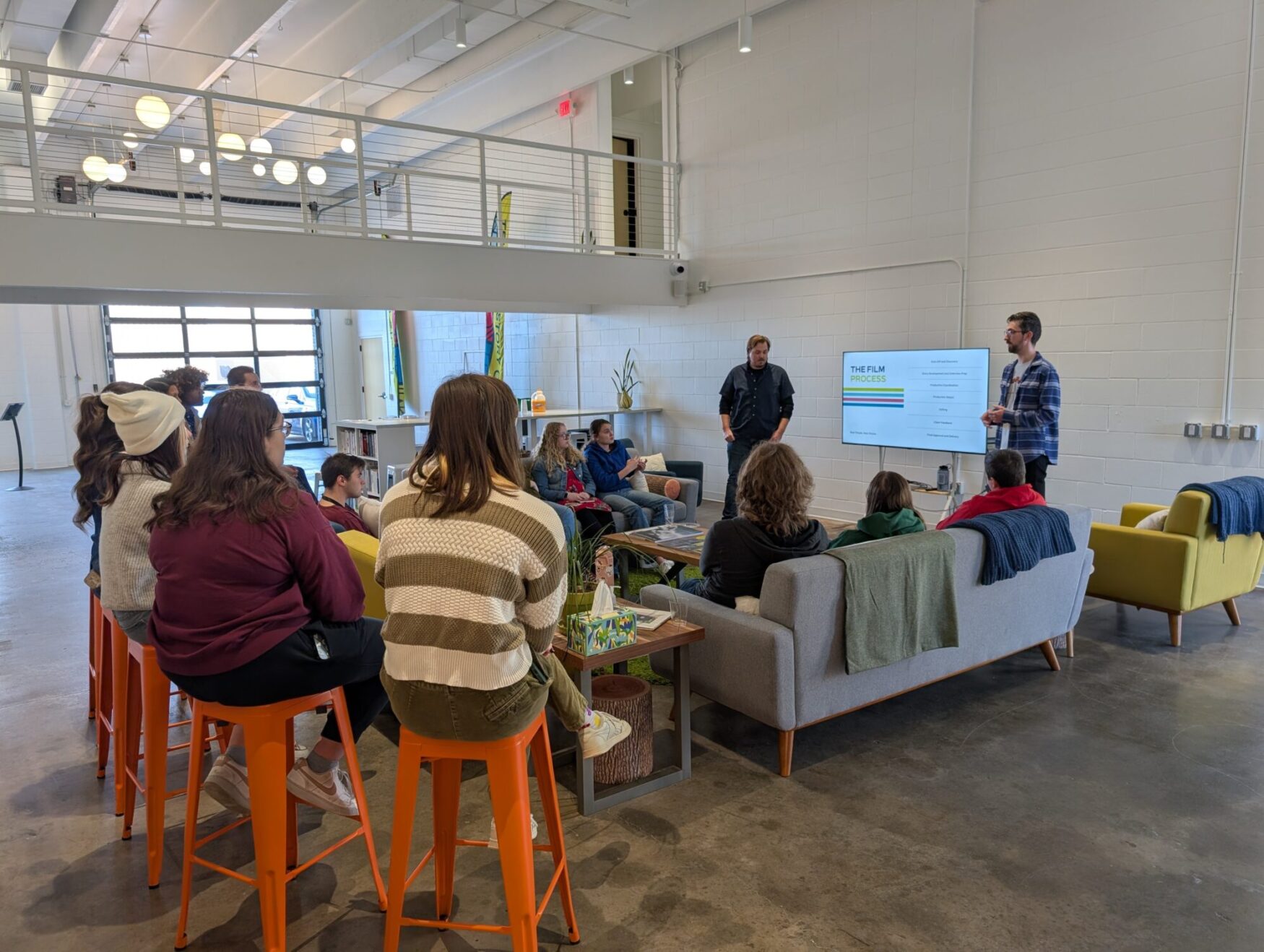 A group of college students listen to Lucas and Matt talk about film at Tellwell.
