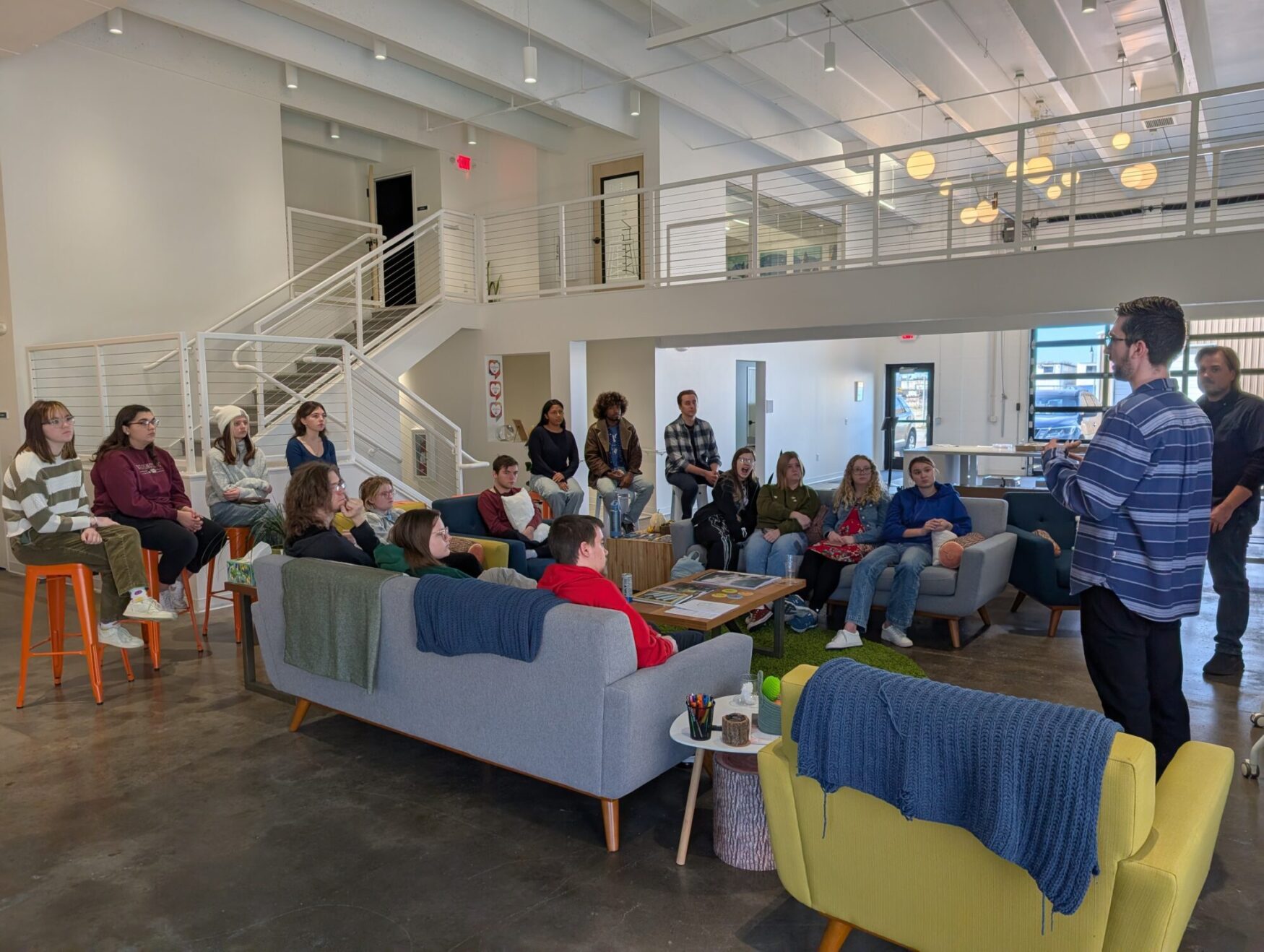 A group of college students listen to Lucas and Matt talk about film at Tellwell.