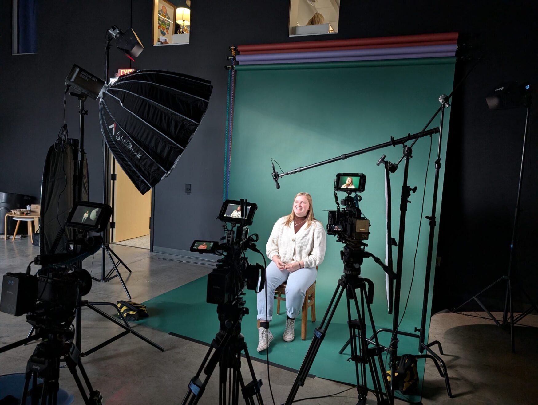 Kari sits in front of the newly installed paper backdrops for our interview setup for an upcoming production.